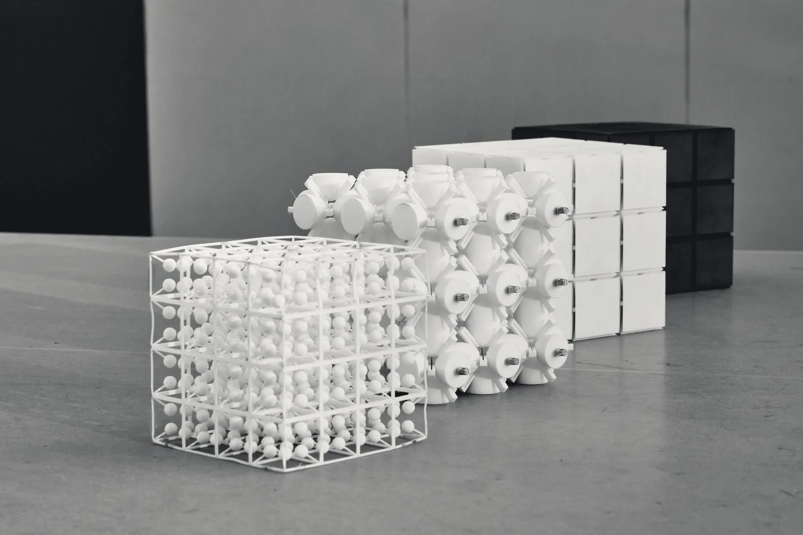Four metamaterial cubes of the same size, each built with a different internal topology